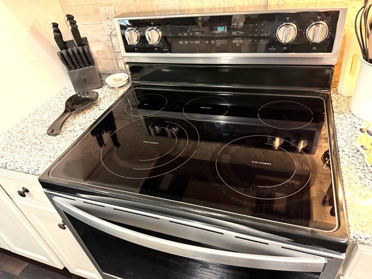 A cleaned range and granite countertop